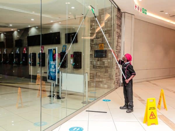 Danspot cleaner mopping a living room floor in Nakuru home