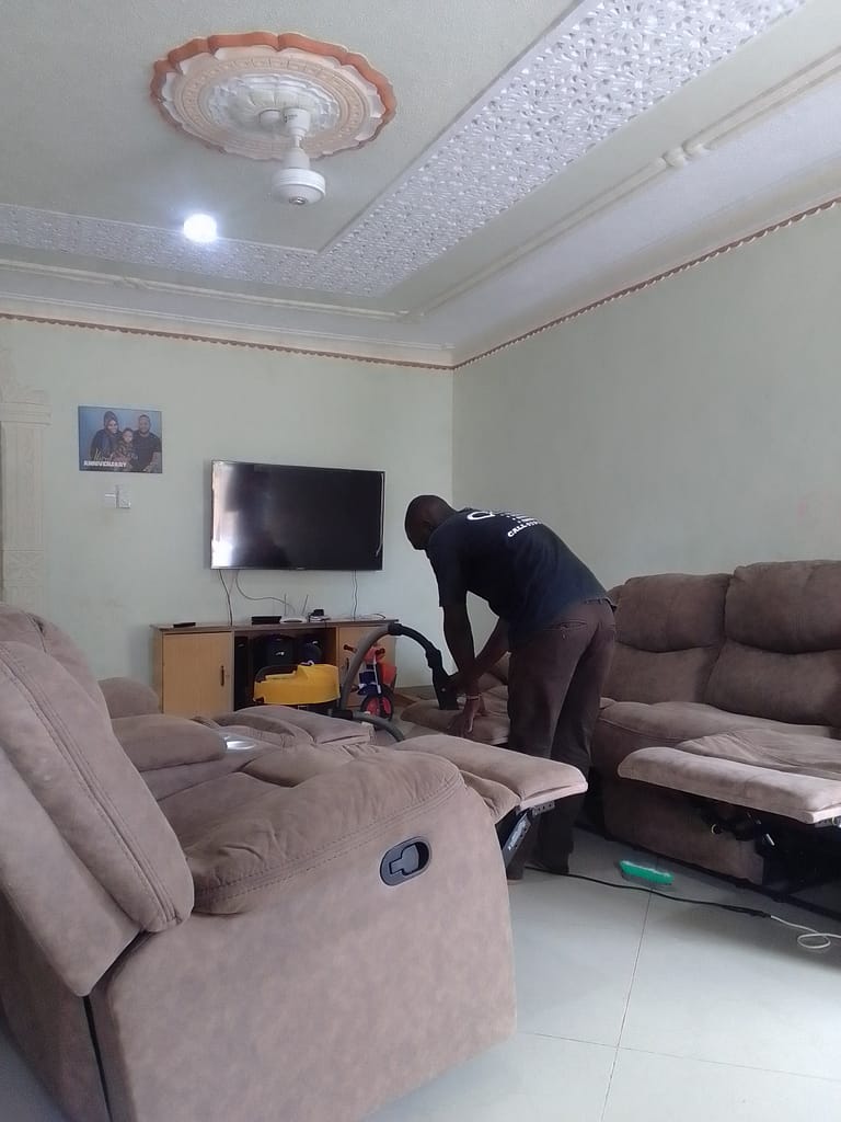 Technician deep cleaning a fabric sofa in Mombasa